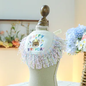 Detail of pet birthday bandana with Happy Birthday embroidery and colorful tassels