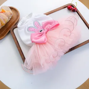Detail of pink tutu pet dress with rabbit embroidery and large satin bow decoration