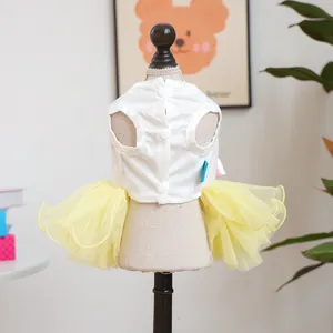 Detail view of pet dress featuring a white vest top with yellow tulle tutu skirt