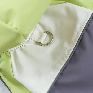Detail of waterproof pet jacket showing D-ring harness attachment and reflective piping