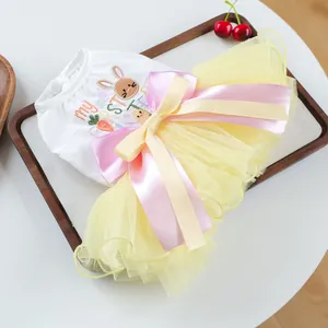 Detail of Easter pet dress with rabbit embroidery and yellow tulle skirt with bow