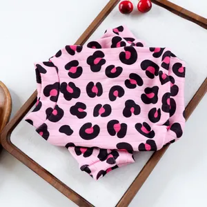 Dettaglio del maglione leopardato rosa per animali con trama a coste su vassoio