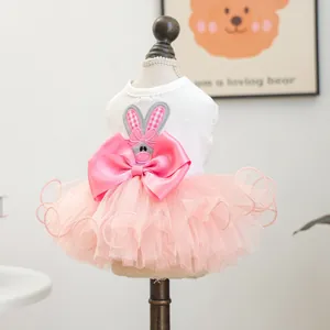 Detail of pink tutu pet dress featuring rabbit embroidery and a large satin bow