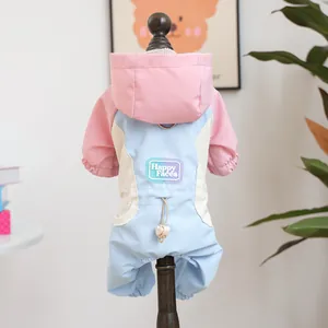 Detail of pink and blue pet jumpsuit showing the Happy Faces label and back D-ring hook