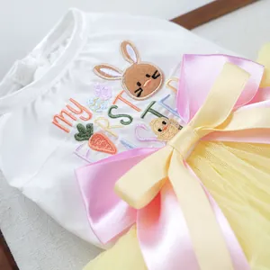 Close-up of Easter pet dress with 'my FIRST Easter' embroidery and large satin bow