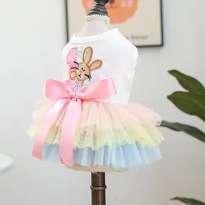 Close-up of rainbow tulle pet dress featuring a pink bow and rabbit embroidery