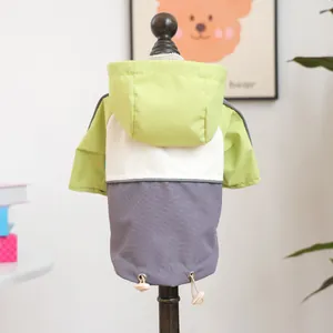 Detail of multi-color hooded pet jacket with adjustable drawstring on dog mannequin
