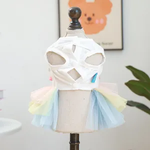 Detailed back view of a white pet dress with rainbow mesh skirt and button closures