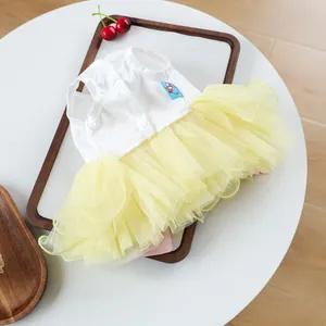 Detail view of pet Easter tutu dress with white vest and layered yellow mesh skirt