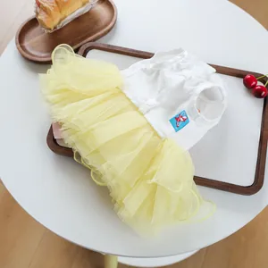 Detail of pet dress featuring a white cotton bodice and yellow layered mesh tutu skirt