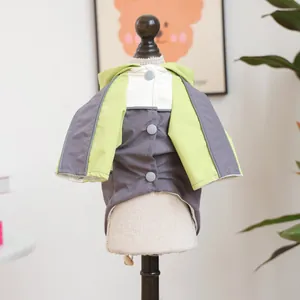 Detail of color-block hooded dog jacket with grey snap buttons and breathable mesh lining