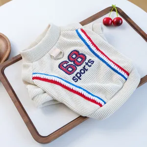 Close-up of knit pet vest with 68 sports embroidery and metal D-ring for leash attachment