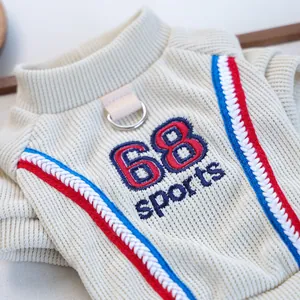 Detail of cream ribbed pet sweatshirt featuring 68 sports embroidery and metal D-ring