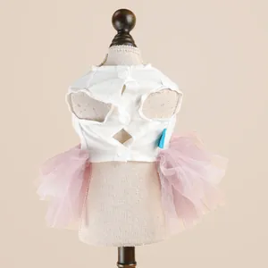 Detail of pink tulle pet dress with white cotton vest and back button closure