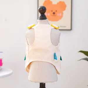 Detail of pet vest with corduroy fabric, adjustable buckle, and green wing decoration