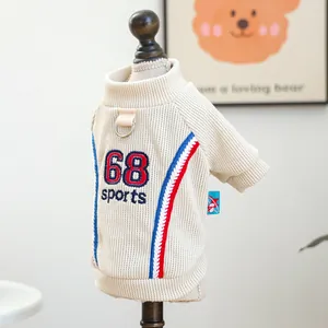 Detail of cream knit dog sweater with 68 sports embroidery and metal D-ring for leash