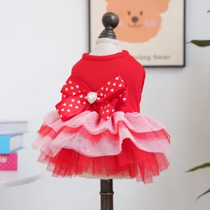 Detail of red pet dress with large heart-patterned bow and layered pink mesh skirt