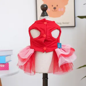 Detail of red and pink mesh pet tutu dress featuring three central back buttons and logo tag