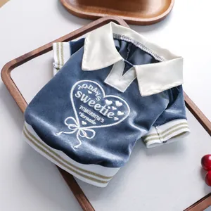 Close-up of heart embroidery and velvet texture on small pet polo shirt with white collar