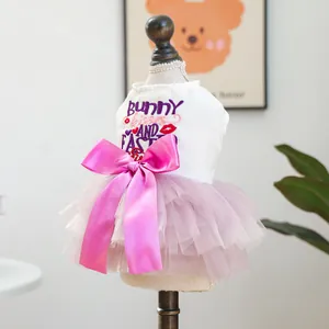 Detail of Easter pet dress with Bunny Kisses embroidery and large pink satin bow