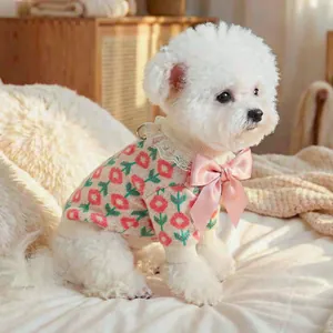 Detail of pet knit sweater with pink floral pattern, lace collar and large satin bow