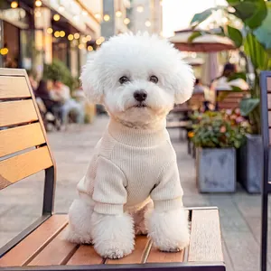 Beige ribbed knit high-neck sweater for small dogs shown on a wooden outdoor chair