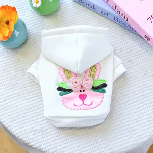 Detail view of white pet hoodie featuring pink bunny embroidery and 3D silk roses