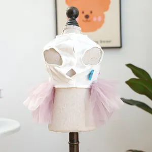 Detailed back view of a pet Easter dress with white vest, purple tulle skirt and buttons