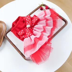 Detailed view of a red pet princess dress with bow, pearl heart, and tiered mesh layers