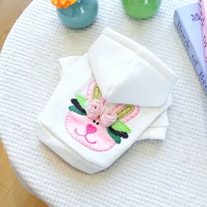 Detail view of Easter dog hoodie with pink bunny patch embroidery and floral 3D accents