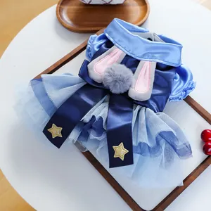 Detail of dog dress featuring light blue tulle skirt with rabbit ears and gold stars