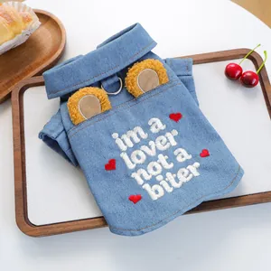 Detail of denim pet vest with cute ears, heart embroidery and metal D-ring for leash