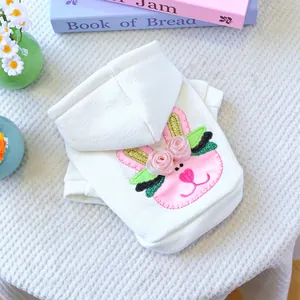 Detail of pet hoodie featuring pink rabbit embroidery and silk rose on cotton fabric