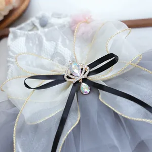 Detail of grey pet wedding dress featuring lace layers and a crystal crown bow accessory