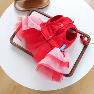Detail of red pet dress with layered mesh tutu skirt and buttons for small dogs