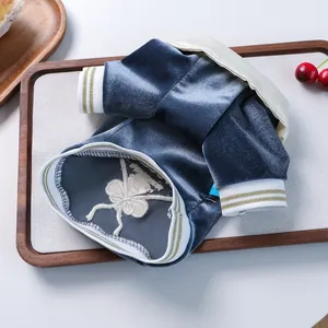 Detail of blue velvet pet polo shirt with white collar and gold-thread ribbed cuffs