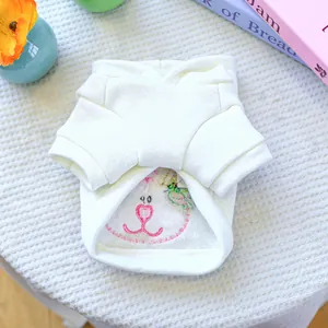 Detail of cream dog hoodie featuring bunny embroidery and soft fleece lining material