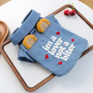 Detail of pet denim jacket with D-ring, yellow plush ears, and embroidery for small dogs