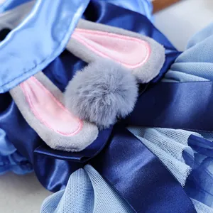 Close-up of royal blue satin pet dress with light blue mesh layers and plush bunny ears