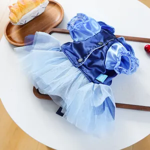 Detail of blue pet dress with satin bodice and layered mesh skirt on white table