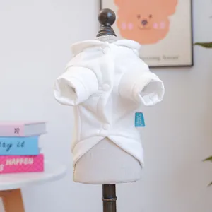 Detail of white pet hoodie showing snap buttons and soft fabric texture on model