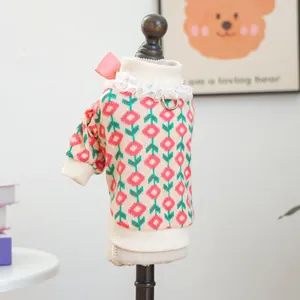 Detail of pet knit sweater featuring tulip patterns, lace collar and a pink bow decoration