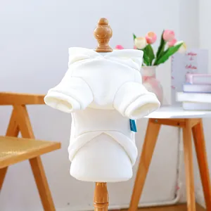 Detail of white pet hoodie showing soft knit fabric and brand label on a wooden model