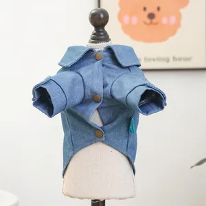 Detail of blue denim pet shirt featuring metallic bronze buttons and classic turn-down collar