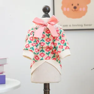 Sweet knit pet sweater with red floral pattern, pink satin bow, and lace collar detail