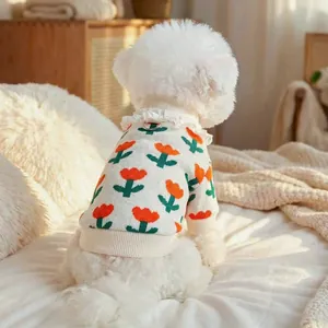 Detail of dog sweater with floral jacquard, lace collar, and functional metal D-ring