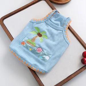 Detailed embroidery of palm trees and starfish on light blue cotton pet vest