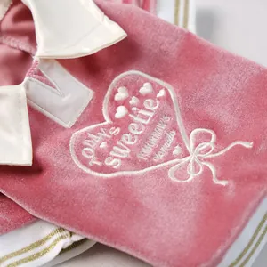 Detail of pink velvet pet polo shirt featuring heart embroidery and sweetie lettering