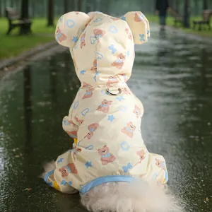 Detail of yellow waterproof dog raincoat with bear prints and a metal leash D-ring
