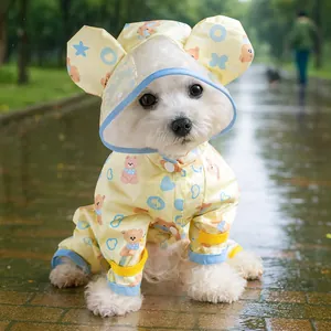 Detail of waterproof dog raincoat with bear print, hood ears and blue trim accents